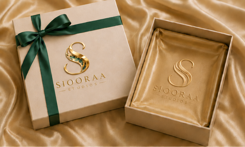 Siooraa Studios satin-lined gift box with gold logo and green ribbon